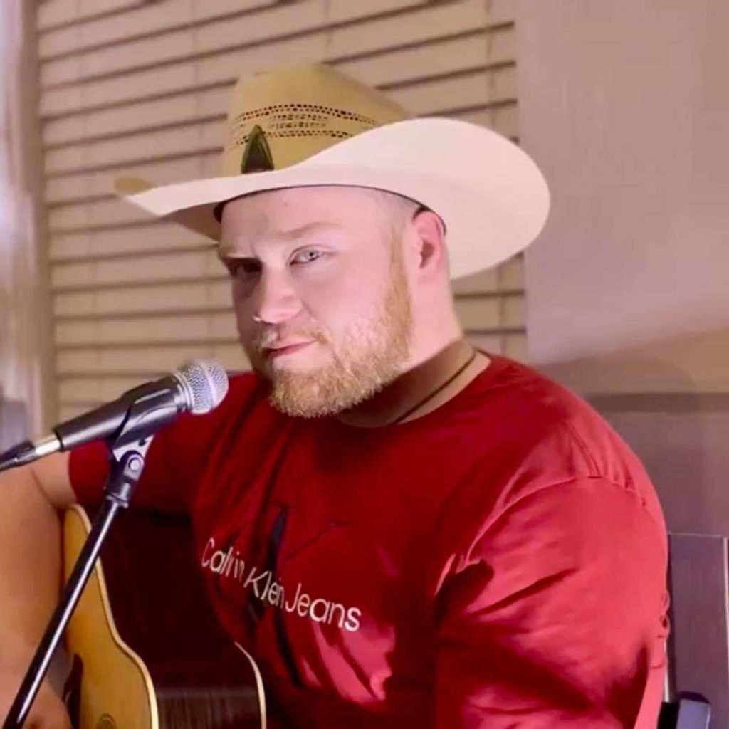 Ethan Allen passionately singing on stage during his homecoming performance in Salyersville, Kentucky.